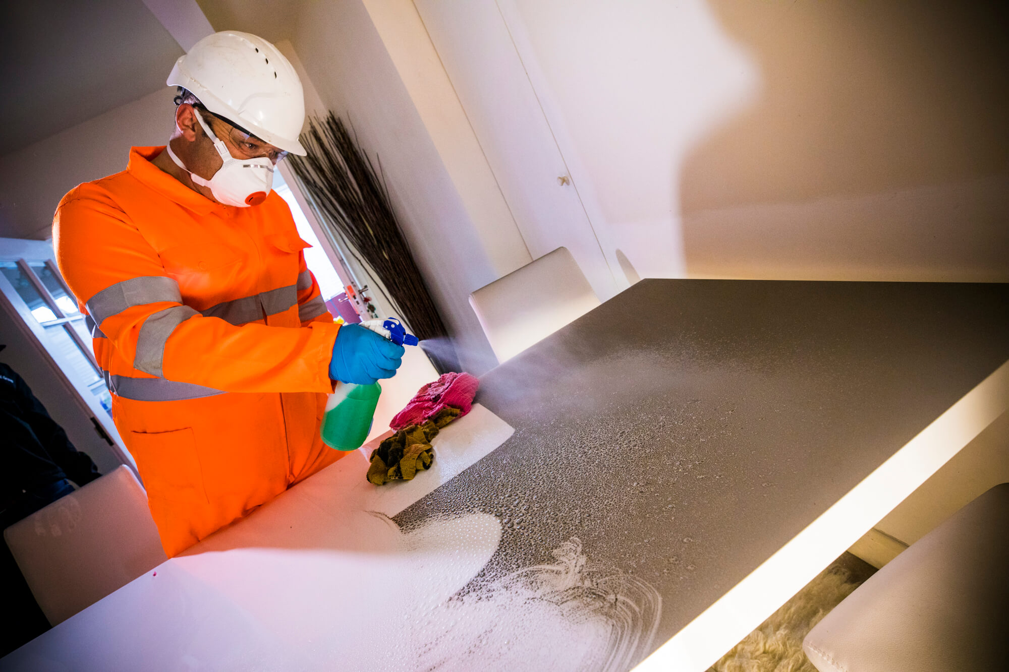 Technician removing soot from table Ideal Response Technician Removing Soot from Table