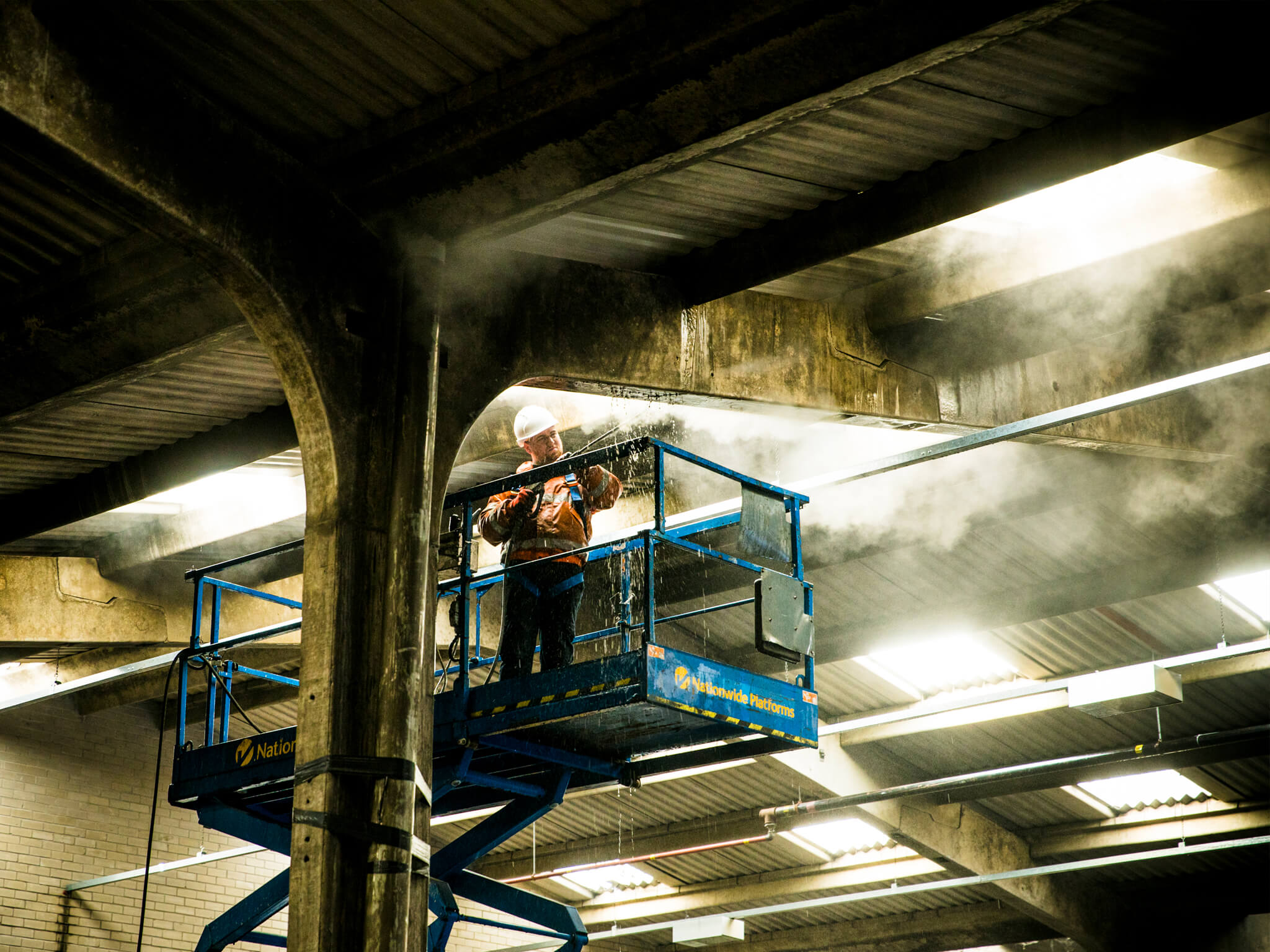 Technician using Doff on Warehouse Ceiling and Beams