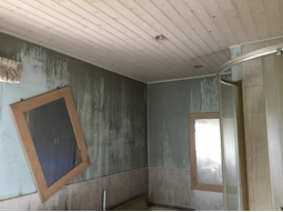soot and smoke damage to walls and ceiling in living room