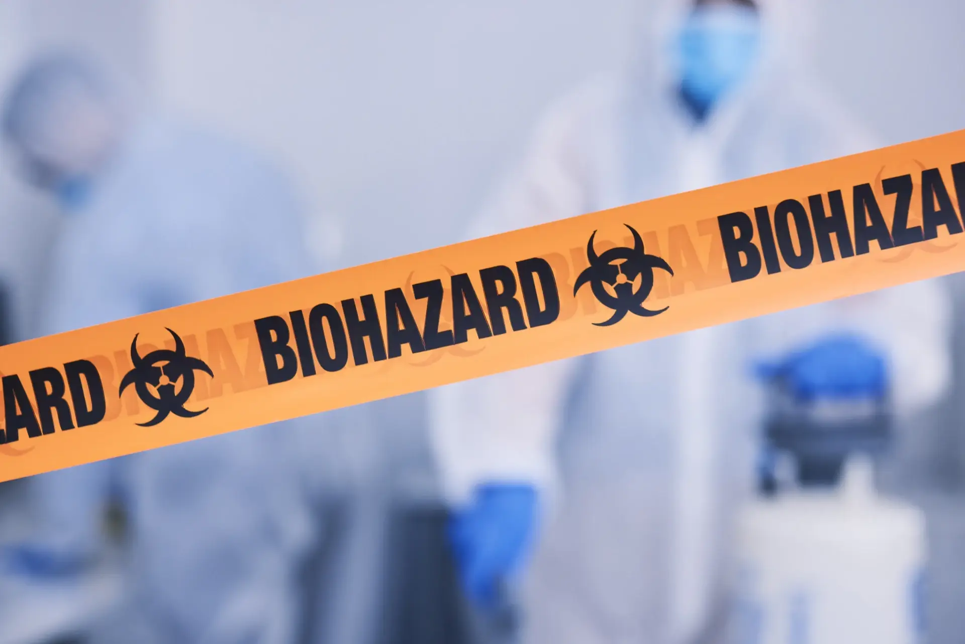 Team of biohazard cleaning technicians working in an infected area
