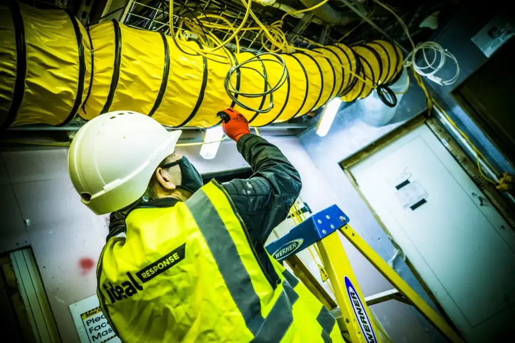 Ideal Response technician installing construction drying equipment