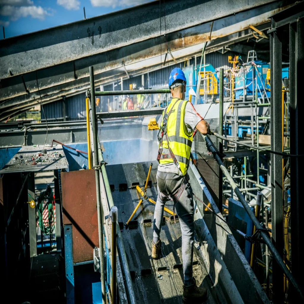 Technician cleaning a manufacturing facility after a fire.