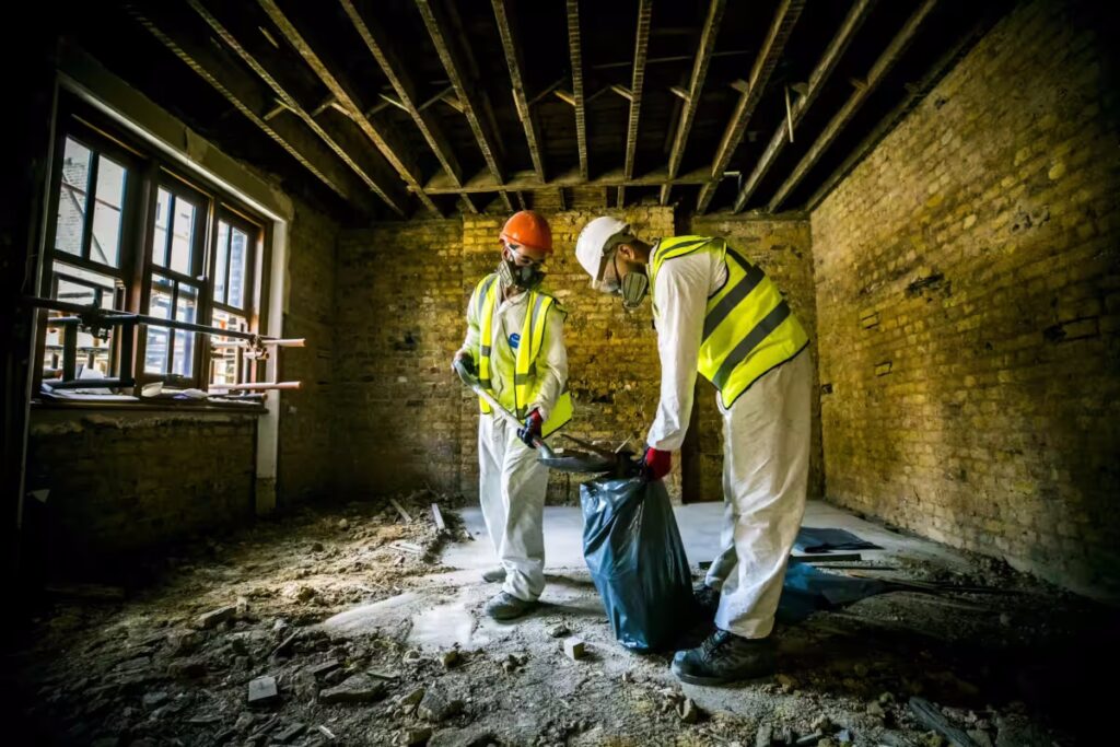 Two specialists cleaning after a fire