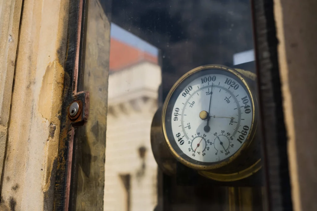 Antique barometer behind glass before causing a mercury spill.