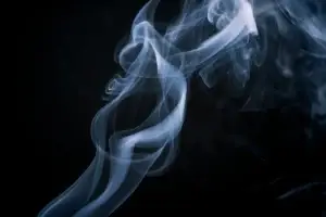 A column of swirling smoke against a black background.