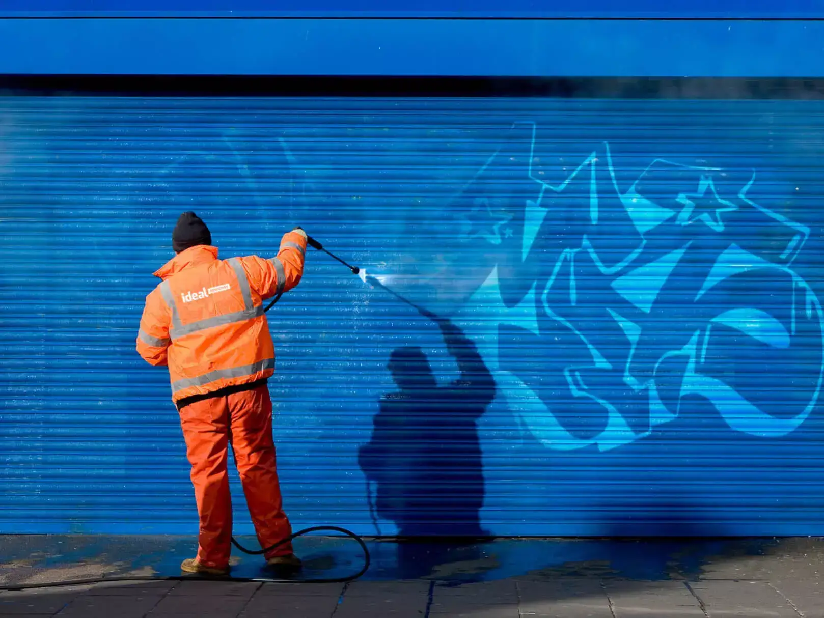 A technician removing graffiti.