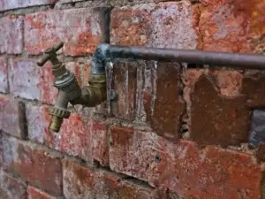 A frozen water pipe with icicles