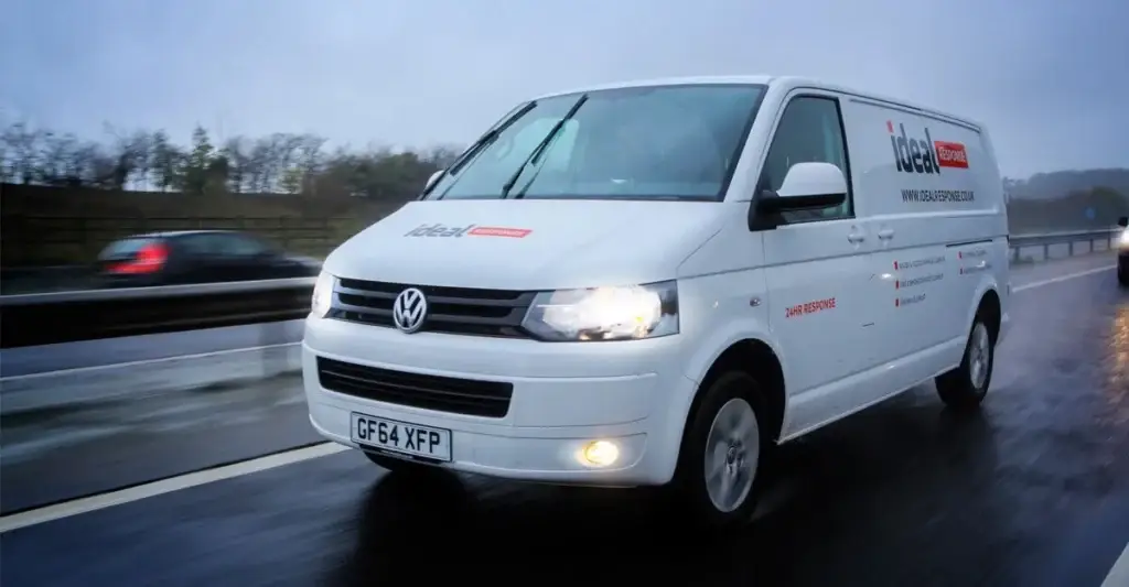 Ideal Response van driving with the headlights on.