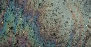 Close up of a hard surface oil spill on concrete.