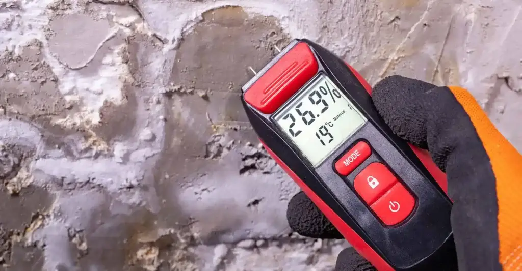 Damp meter being used to carry out a damp survey which will be summarised in a comprehensive damp report.
