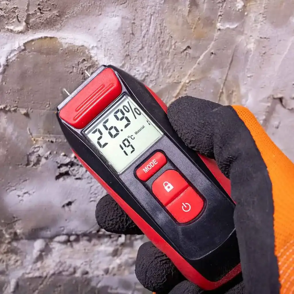 Moistue meter being used during a damp survey.