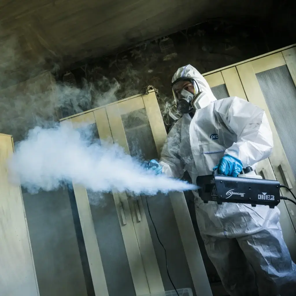 Cleaning technicnas performing smoke odour removal with a fogger.