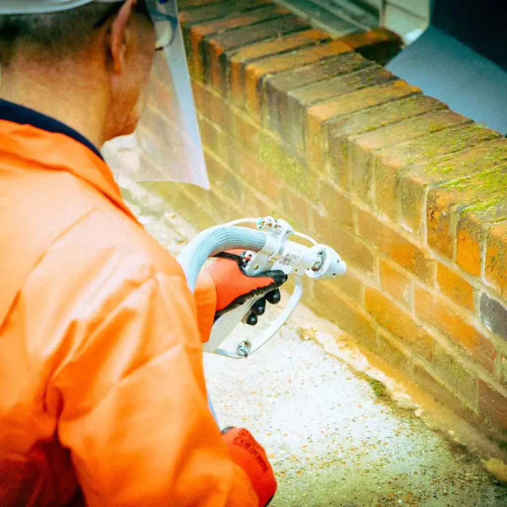 Sandblasting brickwork.