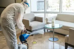 Technician using a fogging machine for odour removal